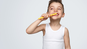 a kid brushing his teeth